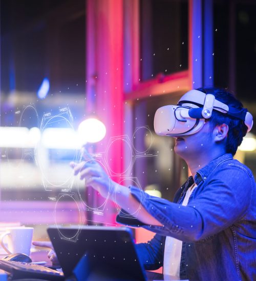 asian young male wearing wearable goggle headset virtual online meeting digital space working with 3d augmented dimension at home,cyber virtual working with virtual vr goggle and pc desktop device